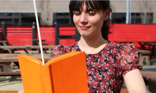 woman reading an orange book